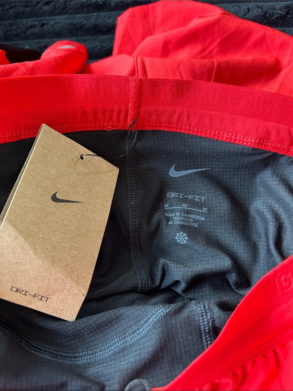 Nike Men's Red Athletic Shorts with Black Trim and White Swoosh